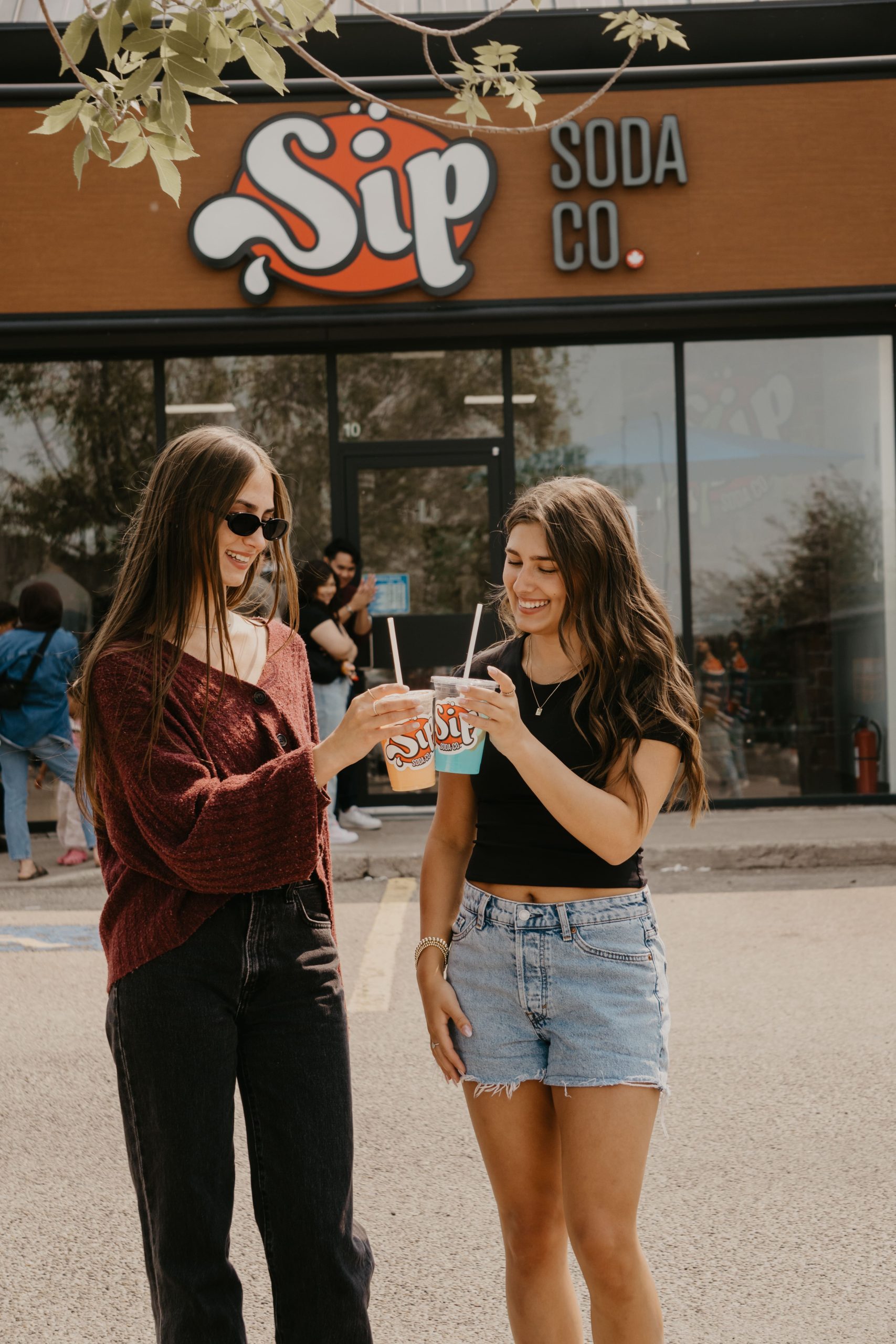Sip Soda Co. customers outside the shop holding dirty sodas