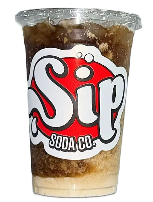 Brown soda and cream in a clear Sip Soda branded cup